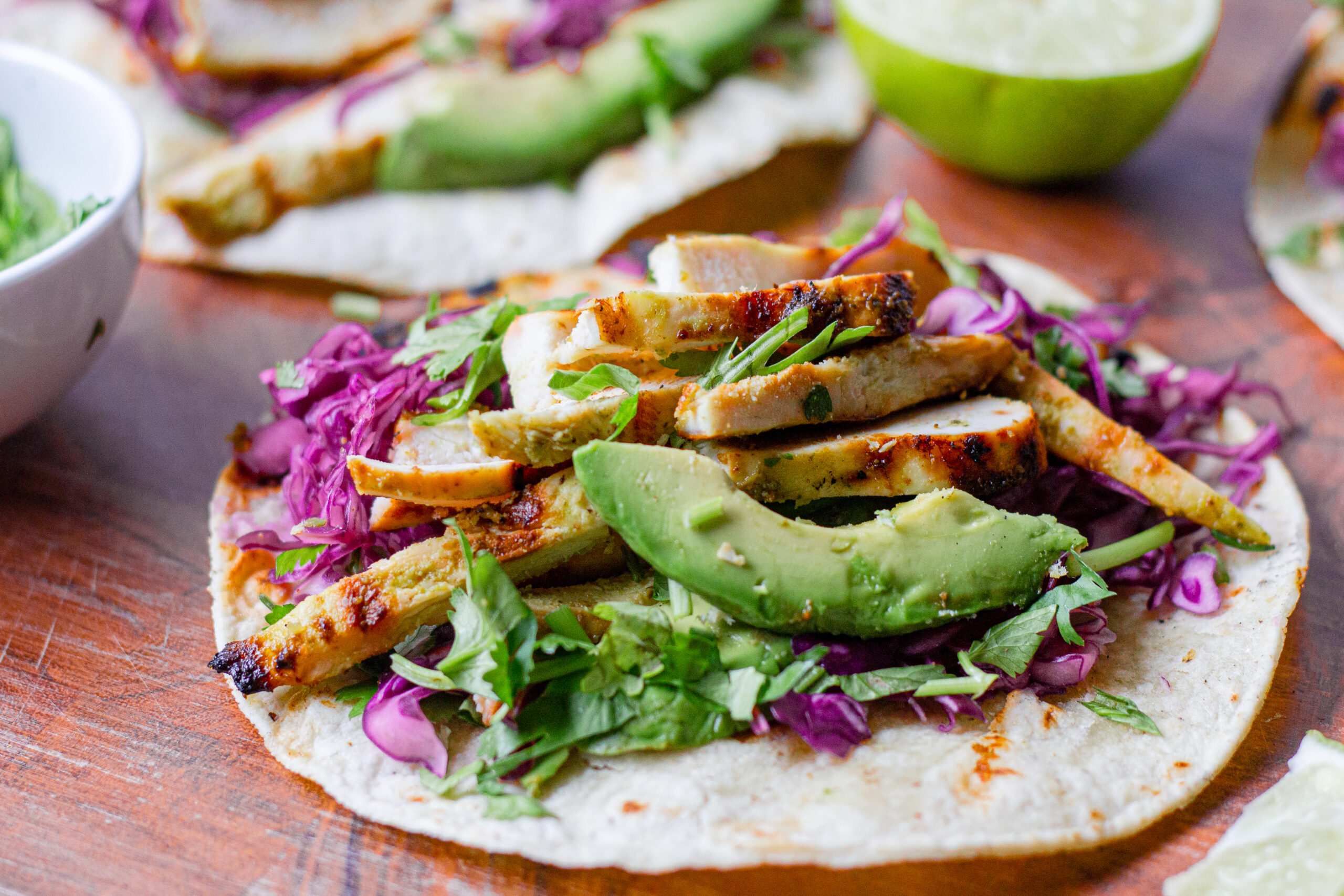 single taco with purple cabbage slaw avocado and cilanto