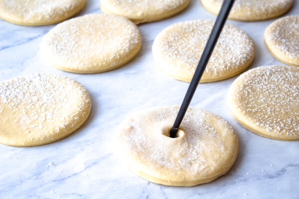 creating a whole in the center of dough with a chopstick