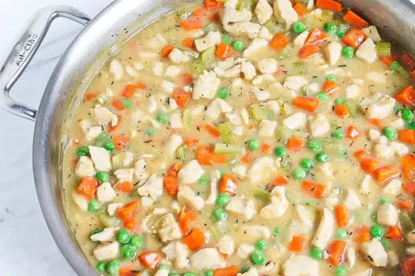 chicken pot pie filling in a stainless steel pot with roux
