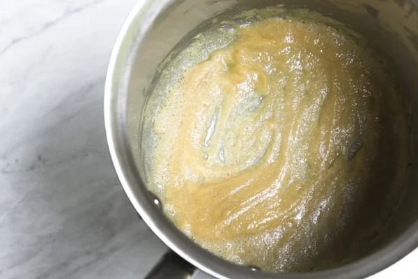 roux made with butter and einkorn flour being cooked in saucepan