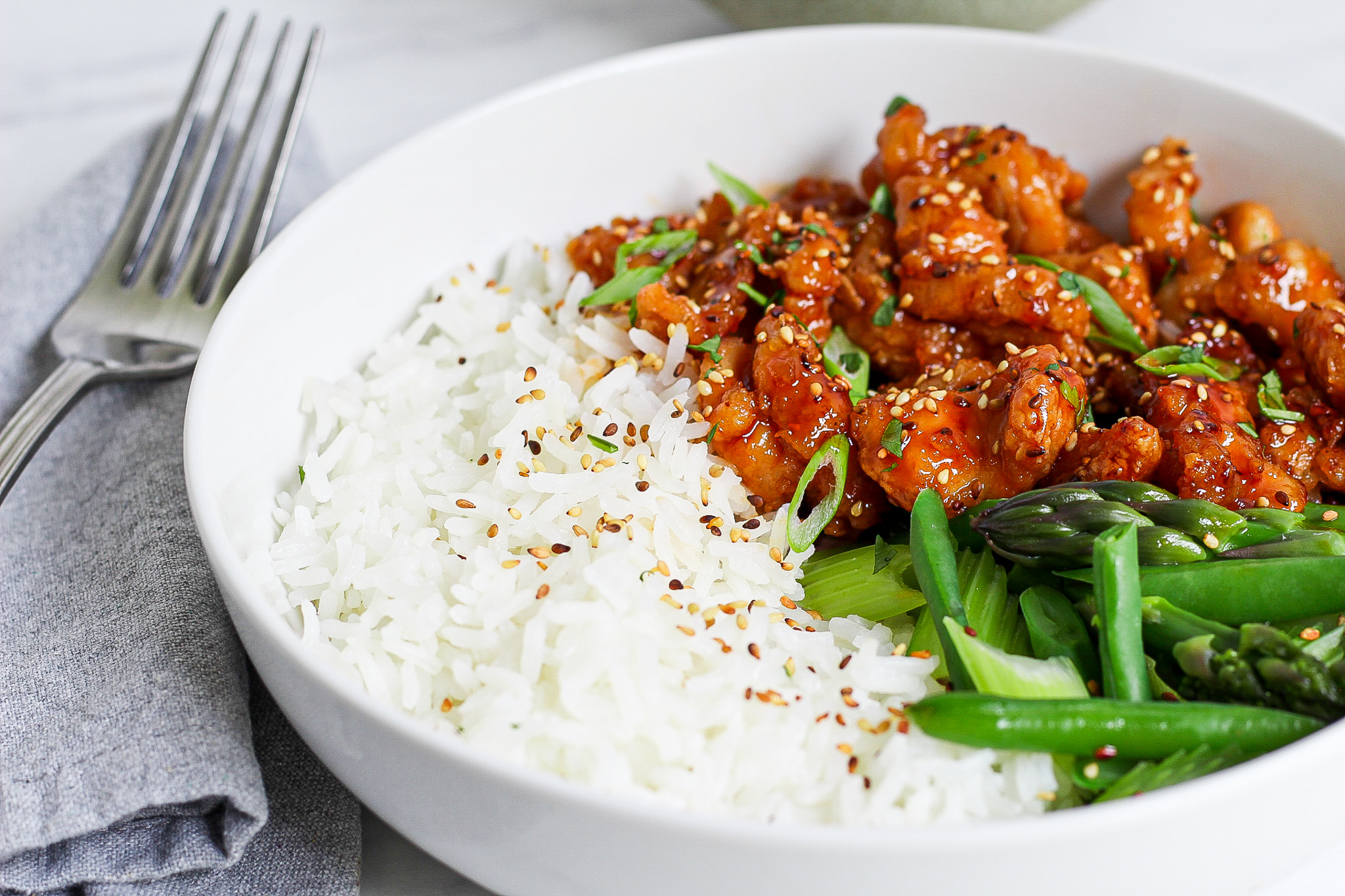 bowl of rice Chinese chicken and green vegetables