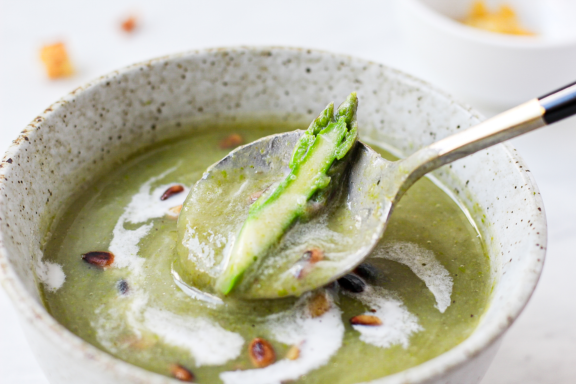 soup spoon scooping asparagus potato soup