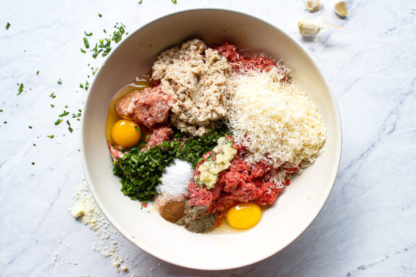 overhead view of all ingredients for italian meatballs combined in a bowl