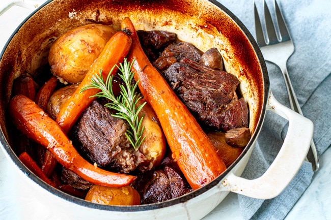 cooked pot roast ingredients in a dutch oven