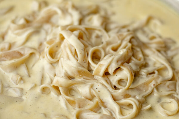Jovial brown rice tagliatelle tossed in parmigiano cream sauce